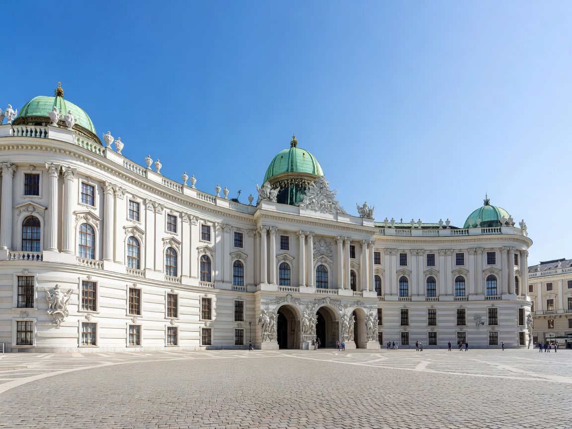 Grand classical architecture of Vienna's imperial palaces under bright blue sky